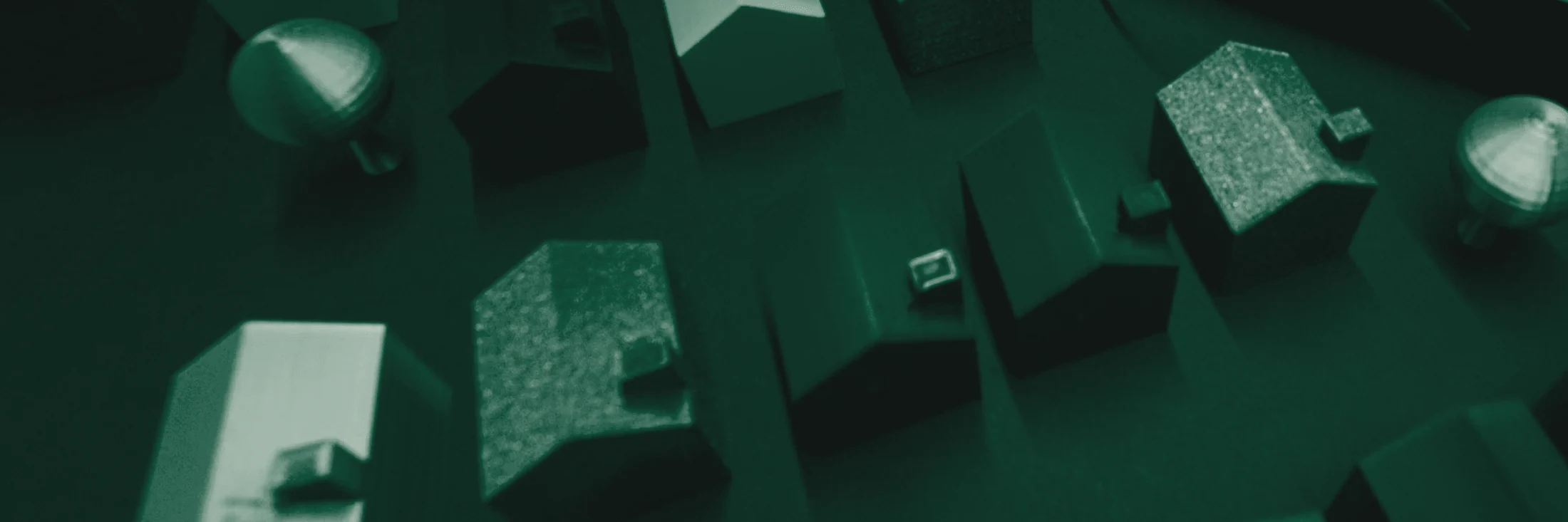 Plateau de table avec maquettes, documents et matériel de travail sous une lumière dirigée